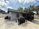 Backyard featuring a covered patio, grill, and ample space for outdoor activities and entertainment at 6922 Doehring Dr, Lakeland, FL 33810