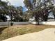 Large partially grassed backyard, fully fenced, with a small concrete pad in the corner at 6922 Doehring Dr, Lakeland, FL 33810