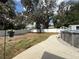 Large, partially grassed backyard featuring a new white fence, shed, and above ground swimming pool at 6922 Doehring Dr, Lakeland, FL 33810