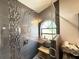 Close-up view of a tiled glass shower with a pebble tile base and window at 6922 Doehring Dr, Lakeland, FL 33810