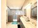 Beautiful bathroom featuring double sinks, granite countertop, tile flooring, and a tiled glass shower at 6922 Doehring Dr, Lakeland, FL 33810