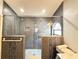 Modern bathroom featuring a glass-enclosed shower, pebble flooring, and unique tiled accents at 6922 Doehring Dr, Lakeland, FL 33810