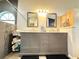Bright bathroom with double vanity, granite countertop, and tiled glass shower with a pebble tile base at 6922 Doehring Dr, Lakeland, FL 33810