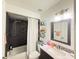 Bathroom featuring a shower-tub, a granite vanity top, floating shelves and modern lighting at 6922 Doehring Dr, Lakeland, FL 33810
