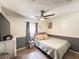 Cozy bedroom with wood-look tile floors, a ceiling fan, and comfortable furnishings at 6922 Doehring Dr, Lakeland, FL 33810