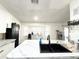 Modern kitchen featuring white cabinets, stainless steel appliances, and tiled floors at 6922 Doehring Dr, Lakeland, FL 33810