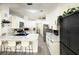 Modern kitchen featuring white cabinets, stainless steel appliances, and tiled floors at 6922 Doehring Dr, Lakeland, FL 33810