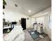 Modern kitchen featuring white cabinets, stainless steel appliances, and tiled floors at 6922 Doehring Dr, Lakeland, FL 33810