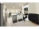 Modern kitchen featuring white cabinets, stainless steel appliances, and tiled floors at 6922 Doehring Dr, Lakeland, FL 33810