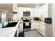Modern kitchen featuring white cabinets, stainless steel appliances, and tiled floors at 6922 Doehring Dr, Lakeland, FL 33810
