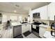 Modern kitchen featuring white cabinets, stainless steel appliances, and tiled floors at 6922 Doehring Dr, Lakeland, FL 33810