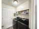 Laundry room featuring tile floors, a full size washer and dryer, and ample shelf storage at 6922 Doehring Dr, Lakeland, FL 33810