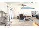 Bright living room features vaulted ceilings, wood-look tile, and a sliding glass door leading to the backyard at 6922 Doehring Dr, Lakeland, FL 33810