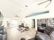 Bright living room with vaulted ceilings, ceiling fan, wood-look tile, and comfortable seating arrangements at 6922 Doehring Dr, Lakeland, FL 33810