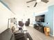 Open living room showcasing tile floors, a ceiling fan, a entertainment center, and comfortable seating at 6922 Doehring Dr, Lakeland, FL 33810