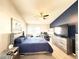 The primary bedroom includes a comfortable queen bed, a ceiling fan, a dedicated office area, and beach themed art at 6922 Doehring Dr, Lakeland, FL 33810