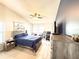 Main bedroom features wood-look tile floors, a ceiling fan, beach themed wall art and a cozy sitting area at 6922 Doehring Dr, Lakeland, FL 33810