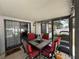 Screened patio featuring a square table with 4 red cushioned chairs and light fixtures at 6922 Doehring Dr, Lakeland, FL 33810