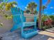 A large, decorative Windsor Hills chair surrounded by various plants and flowers at 7690 Sir Kaufmann Ct, Kissimmee, FL 34747