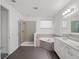 Modern bathroom with tiled shower, separate soaking tub, and double vanity with sleek hardware at 8352 Lookout Pointe Dr, Windermere, FL 34786