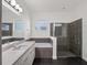 Modern bathroom with a soaking tub, sleek vanity, and frameless glass shower at 8352 Lookout Pointe Dr, Windermere, FL 34786
