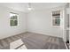 Bright bedroom with neutral carpeting and two windows providing natural light at 8352 Lookout Pointe Dr, Windermere, FL 34786