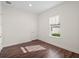 A bright bedroom features neutral paint, hardwood flooring, and a bright window at 8352 Lookout Pointe Dr, Windermere, FL 34786