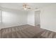 Spacious bedroom featuring neutral carpet, a ceiling fan, and bright white walls at 8352 Lookout Pointe Dr, Windermere, FL 34786