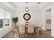 A formal dining room is bright with neutral paint, tray ceilings, hardwood floors and a modern light fixture at 8352 Lookout Pointe Dr, Windermere, FL 34786
