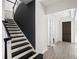 Welcoming entryway with dark wood accents on the staircase and a view of the front door at 8352 Lookout Pointe Dr, Windermere, FL 34786