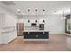 An open-concept kitchen features white cabinets, stainless steel appliances and an island at 8352 Lookout Pointe Dr, Windermere, FL 34786