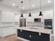 A spacious kitchen featuring white cabinetry, stainless steel appliances, and a center island with bar seating at 8352 Lookout Pointe Dr, Windermere, FL 34786