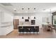 A modern kitchen features white cabinetry, stainless steel appliances, and a dark island with pendant lighting at 8352 Lookout Pointe Dr, Windermere, FL 34786
