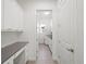 Well-lit laundry room with white cabinetry, a sink, and modern washer and dryer at 8352 Lookout Pointe Dr, Windermere, FL 34786