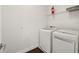Convenient laundry room with modern white washer and dryer at 8352 Lookout Pointe Dr, Windermere, FL 34786