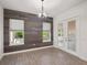 A contemporary living space features neutral paint, hardwood floors, a modern light fixture and a large doorway at 8352 Lookout Pointe Dr, Windermere, FL 34786