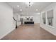 Bright and spacious living room with wood flooring, modern kitchen, and staircase at 8352 Lookout Pointe Dr, Windermere, FL 34786