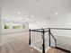 Spacious upstairs loft area with neutral carpeting and staircase at 8352 Lookout Pointe Dr, Windermere, FL 34786