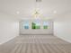 Bright and airy upstairs loft space with ample natural light and neutral carpeting at 8352 Lookout Pointe Dr, Windermere, FL 34786