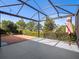 Screened in patio with outdoor ceiling fan, patio furniture and view of backyard at 8352 Lookout Pointe Dr, Windermere, FL 34786
