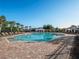 Community pool featuring lounge chairs, a large gazebo, and lush green landscaping at 8352 Lookout Pointe Dr, Windermere, FL 34786