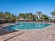 A large community pool featuring a gazebo, lounge chairs, and a brick pool deck at 8352 Lookout Pointe Dr, Windermere, FL 34786