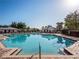 Community pool with blue water, brick deck, lounge chairs, and shady gazebos at 8352 Lookout Pointe Dr, Windermere, FL 34786