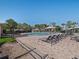 Community pool featuring lounge chairs, a gazebo, lush landscaping, and blue water at 8352 Lookout Pointe Dr, Windermere, FL 34786