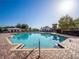 Community pool with blue water, brick deck, lounge chairs, and shady gazebos at 8352 Lookout Pointe Dr, Windermere, FL 34786