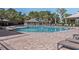 Community pool with a gazebo, lounge chairs, a brick deck, and clear blue water at 8352 Lookout Pointe Dr, Windermere, FL 34786