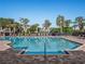 Community pool with a brick deck, gazebo, lounge chairs, and a clear blue sky at 8352 Lookout Pointe Dr, Windermere, FL 34786
