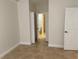 Neutral paint and tile flooring in this bedroom leads to an en-suite bathroom and walk-in closet at 2550 Bella Vista Dr, Davenport, FL 33897
