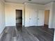 Bright bedroom with wood-look floors, crown molding, white trim, and bathroom access at 2550 Bella Vista Dr, Davenport, FL 33897