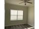 Bedroom with wood-look flooring, ceiling fan, double window and neutral wall color at 2550 Bella Vista Dr, Davenport, FL 33897